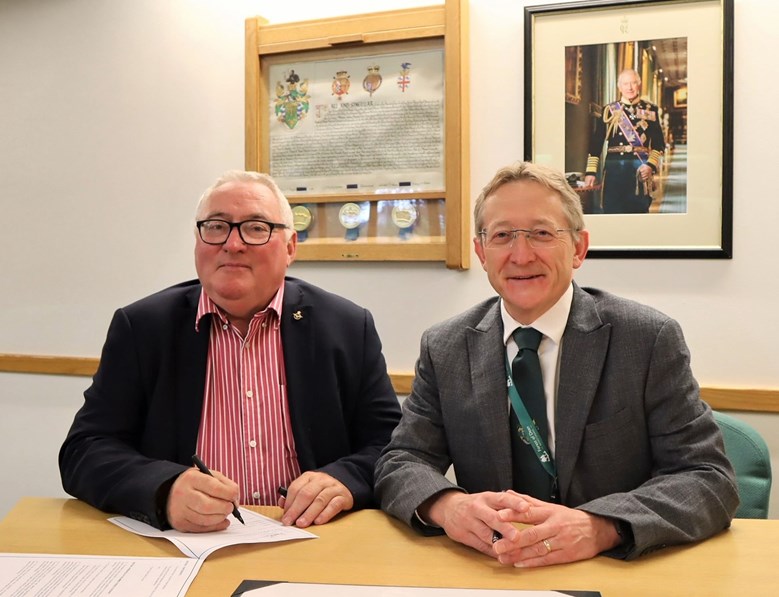 Image of Cllr Alan Preest and Chief Executive Nigel Brinn signing the Armed Forces Covenant